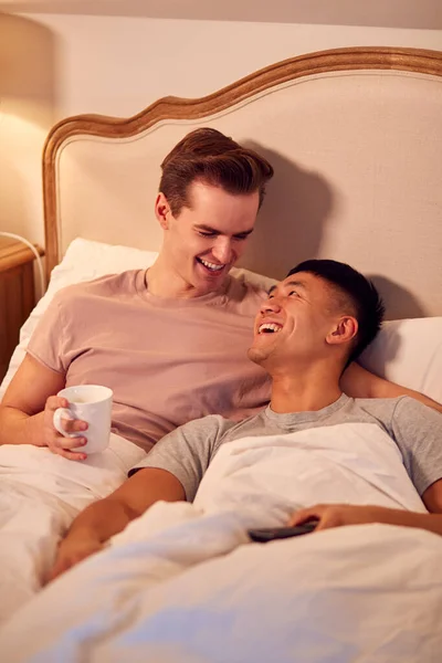 Loving Same Sex Male Couple Lying Bed Home Watching Together — Stok fotoğraf