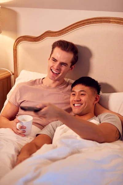 Loving Same Sex Male Couple Lying Bed Home Watching Together — Stok fotoğraf