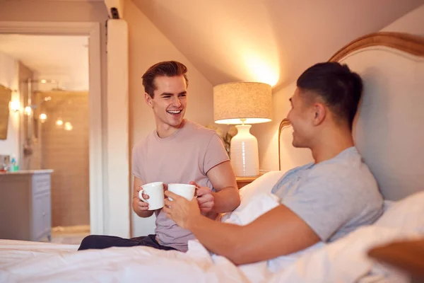 Loving Same Sex Male Couple Bed Home Drinking Hot Drink — стоковое фото
