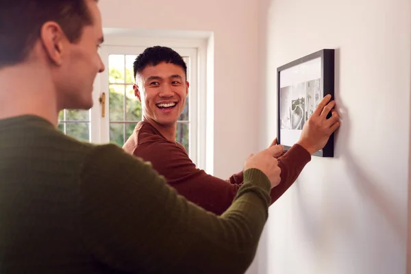 Same Sex Male Couple Hanging Picture Wall Home Together — Stock Photo, Image