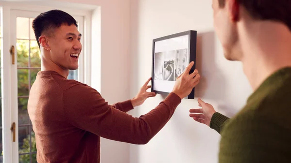 Same Sex Male Couple Hanging Picture Wall Home Together — Stock Photo, Image