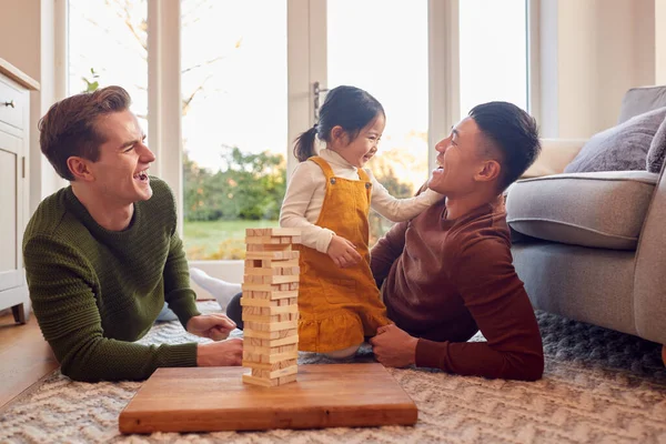Family Two Dads Playing Game Daughter Home Stacking Wooden Bricks — стокове фото
