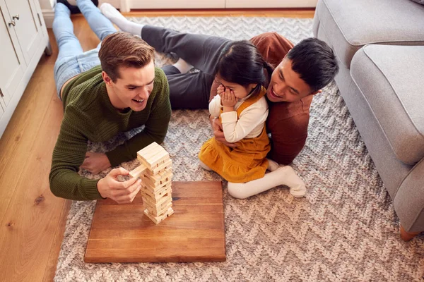 Family Two Dads Playing Game Daughter Home Stacking Wooden Bricks — стокове фото