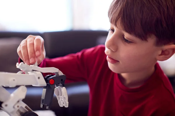 Boy Wearing Pyjamas Building Robotic Arm Plastic Kit Home — Foto Stock