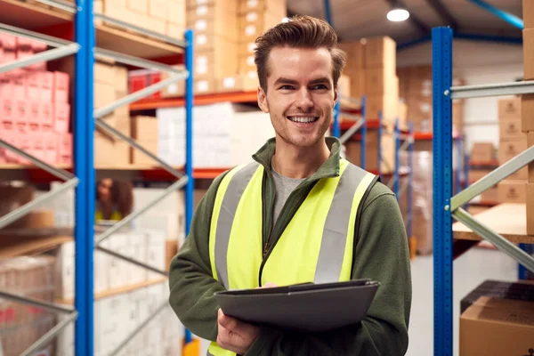 Male Worker Wearing High Vis Vest Busy Warehouse Checking Stock — Fotografia de Stock