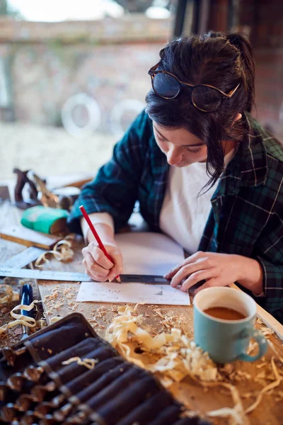 Young Female Carpenter Drawing Measuring Woodwork Design Garage Workshop — ストック写真