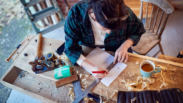 Young Female Carpenter Drawing Measuring Woodwork Design Garage Workshop — ストック写真