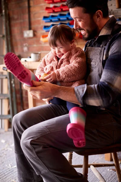 Father Helping Syndrome Daughter Put Wellington Boots Garage Workshop Home — Stock fotografie