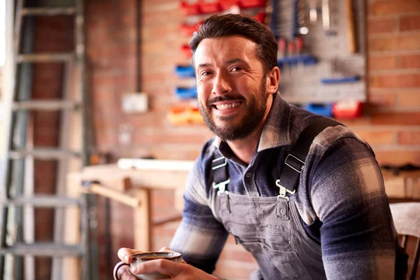 Portrait Smiling Man Wearing Overalls Garage Workshop Hot Drink — Zdjęcie stockowe