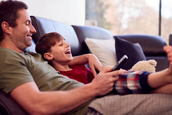 Father Son Toy Dog Sitting Sofa Pyjamas Together Watching — ストック写真