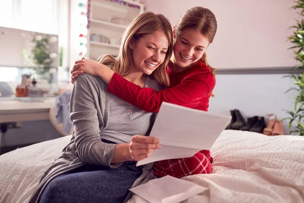 Smiling Teenage Daughter Wearing Pyjamas Looking School Exam Report Mother —  Fotos de Stock