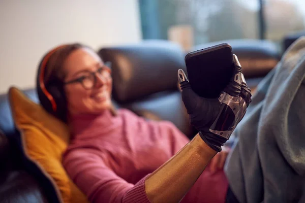 Woman Prosthetic Arm Wearing Wireless Headphones Listening Music Mobile Phone — Photo