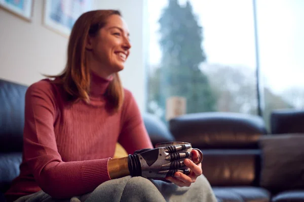 Close Woman Prosthetic Arm Hand Relaxing Sofa Home Drinking Cup — Stockfoto
