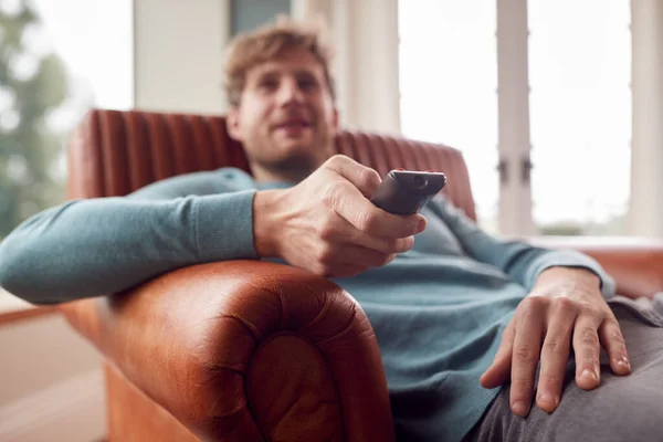 Man Sitting Relaxing Armchair Home Watching Using Remote Control — Foto Stock