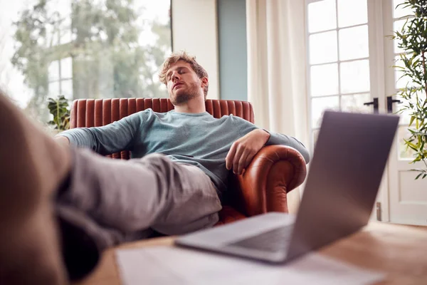 Tired Man Sleeping Armchair Feet Home Laptop Foreground — Fotografia de Stock
