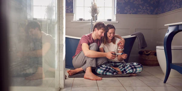 Excited Couple Woman Prosthetic Arm Sitting Bathroom Floor Positive Pregnancy — 스톡 사진