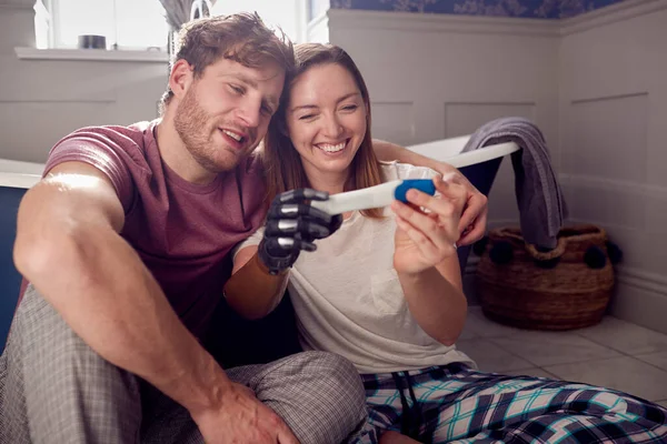 Excited Couple Woman Prosthetic Arm Sitting Bathroom Floor Positive Pregnancy — Stockfoto