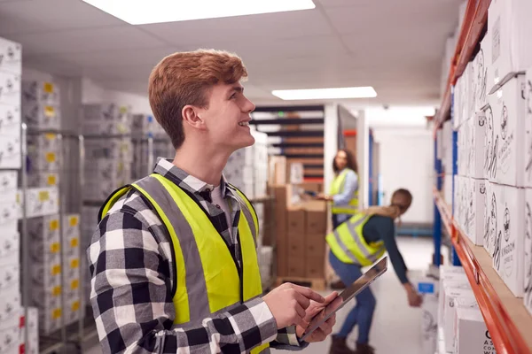 Male Worker Busy Warehouse Checking Stock Shelves Using Digital Tablet — Foto de Stock