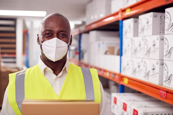 Portrait Male Worker Wearing Ppe Face Mask Holding Box Warehouse — стоковое фото