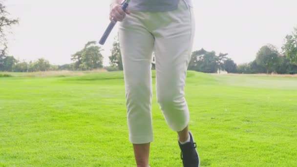 Mature Woman Golf Club Walks Man Sitting Buggy Shot Slow — Video