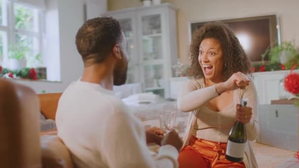 Loving Couple Celebrating Opening Bottle Champagne Christmas Tree Home Shot — Stockvideo