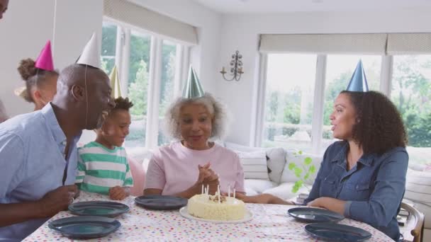 Multi Generation Family Sitting Table Home Celebrating Grandmother Birthday Shot — Stockvideo