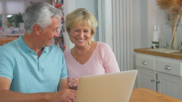 Smiling Senior Retired Couple Sitting Table Home Making Video Call — Vídeo de Stock