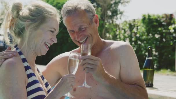 Seniorenpaar Trinkt Sommerurlaub Ein Glas Champagner Freibad Zeitlupe Gedreht — Stockvideo