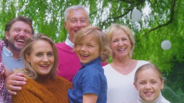 Camera Tracks Faces Smiling Multi Generation Family Home Garden Together — Stockvideo