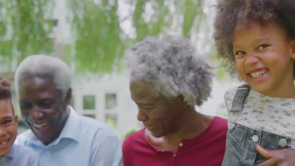 Camera Tracks Faces Smiling Grandchildren Grandparents Home Garden Together Shot — Stok video