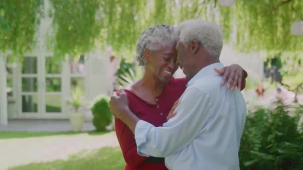 Loving Senior Couple Standing Garden Home Hugging Retirement Shot Slow — Wideo stockowe