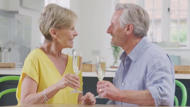 Kissing Retired Couple Celebrating Glass Champagne Making Toast Home Date — Vídeos de Stock