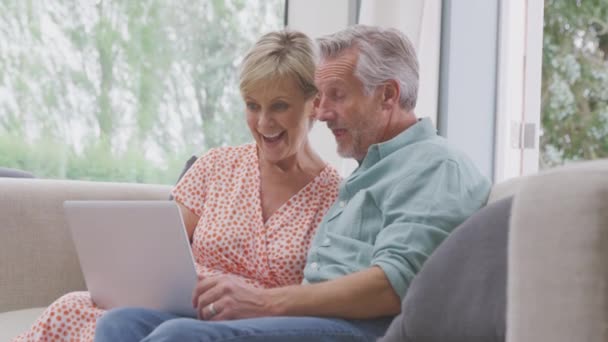 Smiling Senior Retired Couple Sitting Sofa Home Making Video Call — Vídeo de Stock