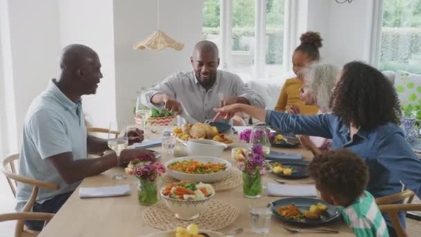 Father Carving Multi Generation Family Sit Table Home Enjoy Eating — Wideo stockowe