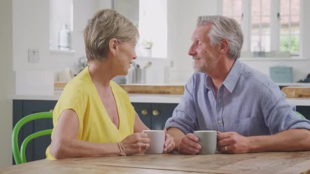 Loving Retired Senior Couple Sit Table Home Kitchen Morning Coffee — Stockvideo