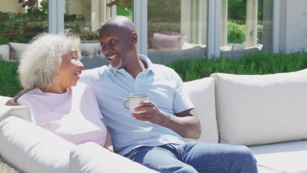 Loving Retired Couple Sitting Outdoors Home Having Morning Coffee Together — Stok video