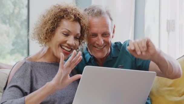 Smiling Senior Retired Couple Sitting Sofa Home Making Video Call — Stock Video