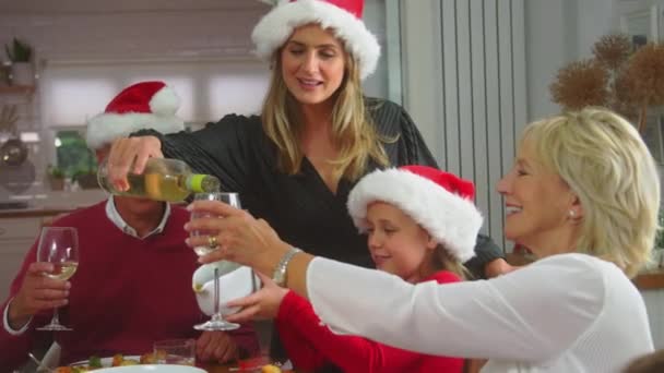 Mother Pouring Glasses Wine Multi Generation Family Sit Eat Christmas — Stockvideo