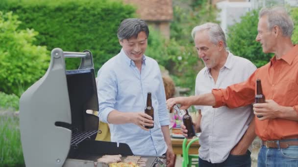 Three Senior Male Friends Cooking Outdoor Barbeque Drinking Beer Home — Video Stock