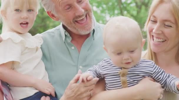 Camera Tracks Faces Smiling Grandparents Mother Grandchildren Home Garden Together — Wideo stockowe