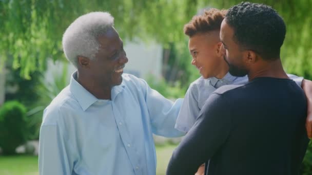 Loving Grandfather Adult Son Grandson Hugging Talking Garden Together Shot — Stock Video