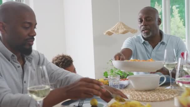 Männliche Mehrgenerationenfamilie Sitzt Hause Tisch Und Genießt Das Gemeinsame Essen — Stockvideo