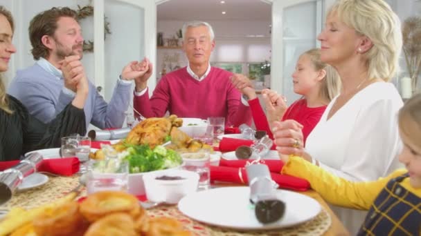 Multi Generation Family Hold Hands Table Home Saying Grace Eating — Stockvideo