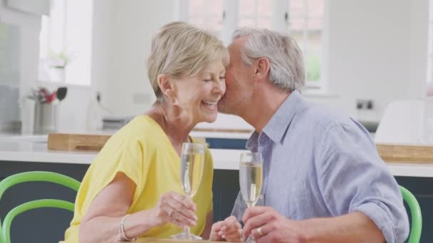 Kissing Retired Couple Celebrating Glass Champagne Making Toast Home Date — Vídeos de Stock