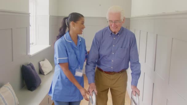 Senior Man Home Using Walking Frame Being Helped Female Care — Stockvideo