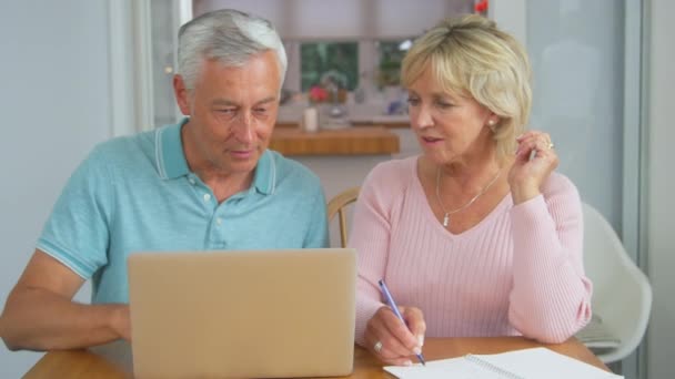Senior Retired Couple Sitting Table Home Reviewing Personal Finances Laptop — ストック動画