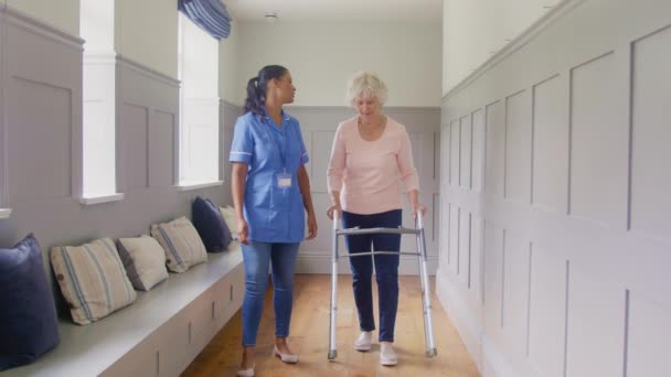 Senior Woman Home Using Walking Frame Being Helped Female Care — Videoclip de stoc