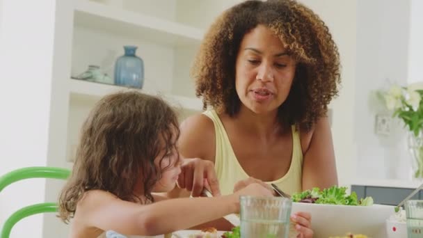 Mother Helping Daughter Cut Food Sitting Table Kitchen Home Eating — Video Stock