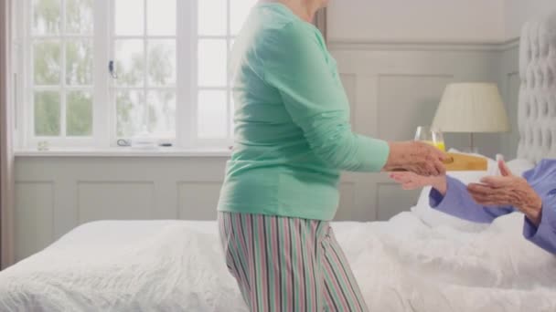 Senior Couple Home Woman Bringing Breakfast Tray Senior Man Bed — Stockvideo