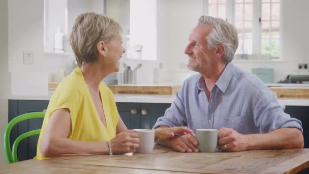 Retired Senior Couple Sitting Table Home Kitchen Morning Coffee Talk — Stockvideo